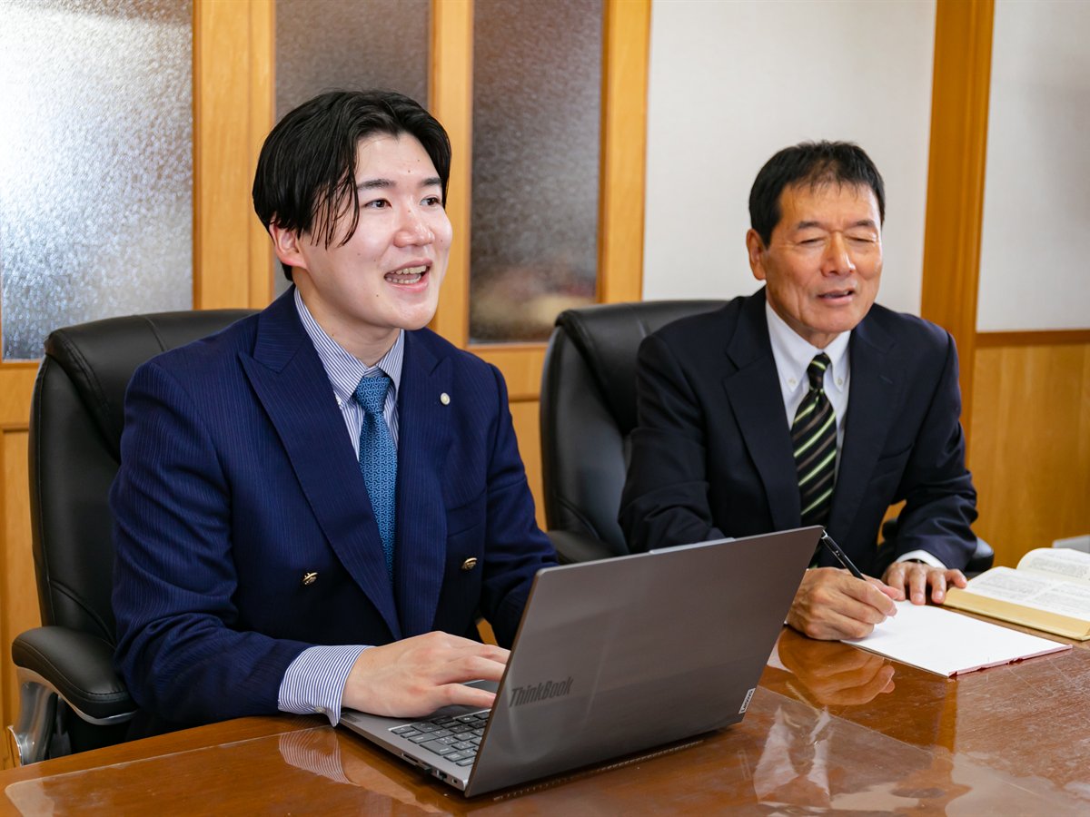 会社設立の相談に対応する岩田司法書士事務所の司法書士二名